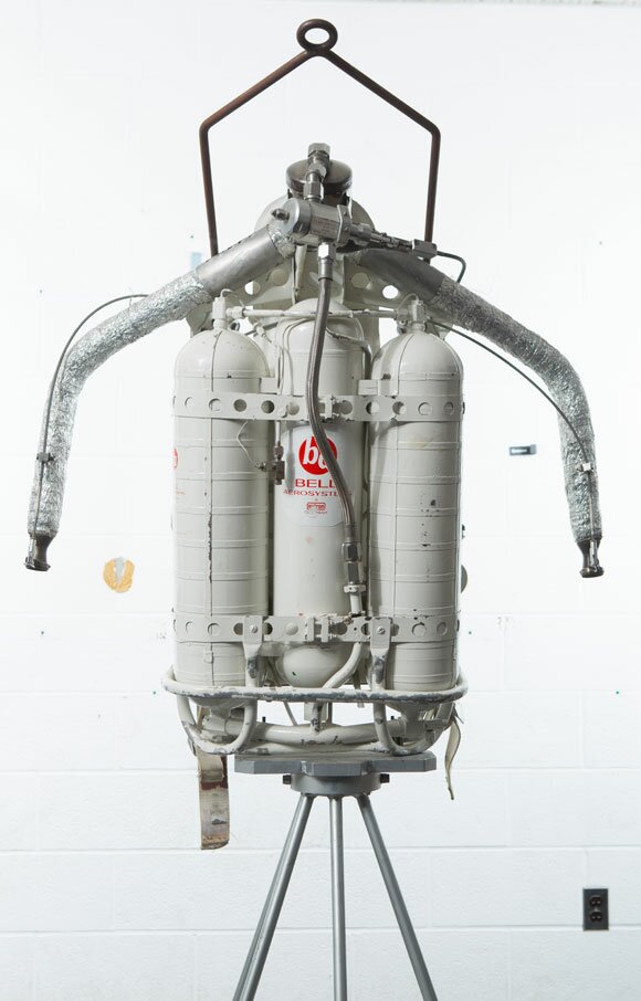 A device with three white tanks fastened together.